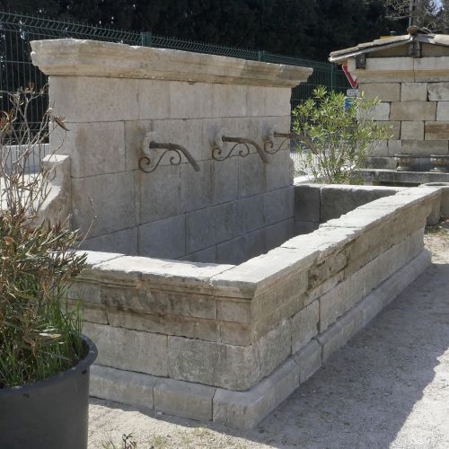 Large fontaine rustique en vieilles pierres patinées par le tailleur de pierre en Provence Alain BIDAL