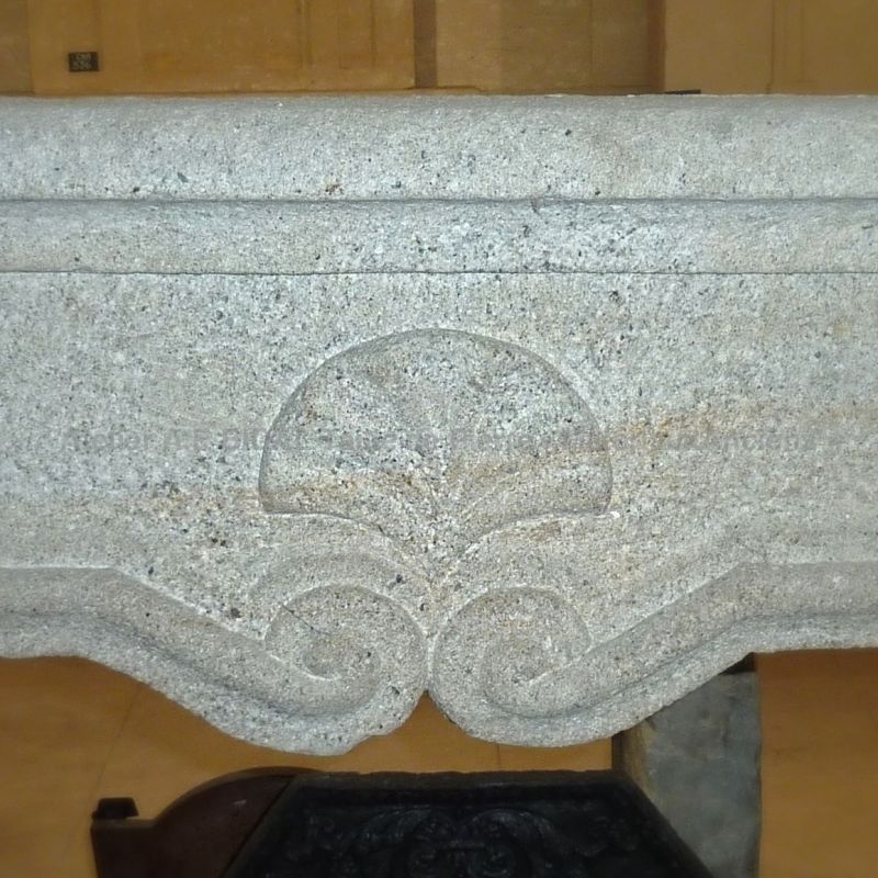 Beautiful decoration on our ancient Louis 15 fireplace made of granite.