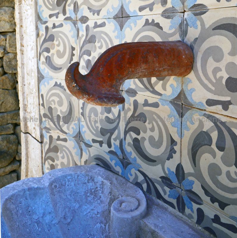 Gadrooned sink in stone fitted in an alcove decorated with reclaimed cement tiles: Atelier Alain BIDAL (Provence)