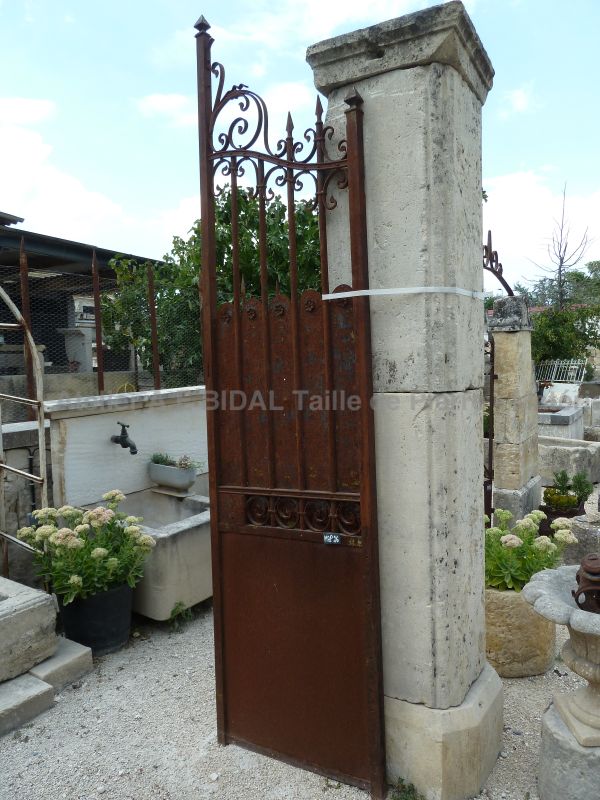 Old gate made of wrought iron delicately decorated with small flowers (part that isn't openwork)).