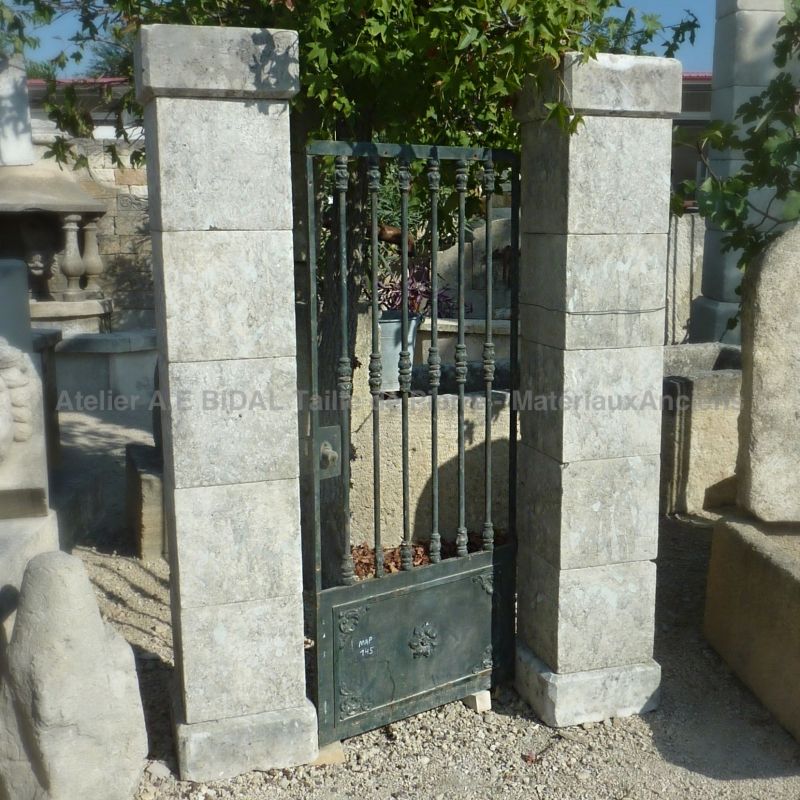 Stone pillars - a pair of rustic pillars made of old stone for outdoor use with a small gate for example.