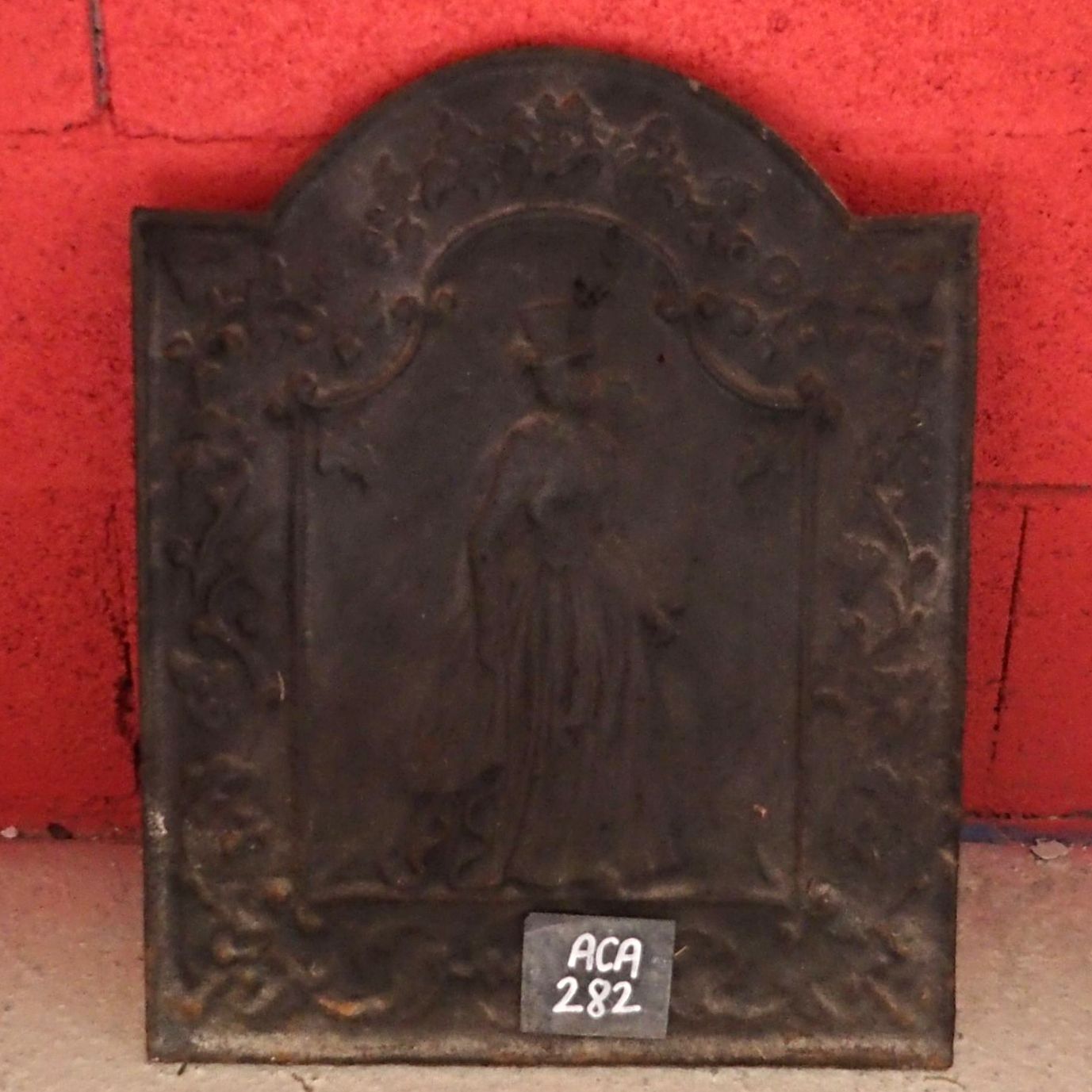 Cast iron fireback representing a woman as well as plants - our old fireplace accessories.