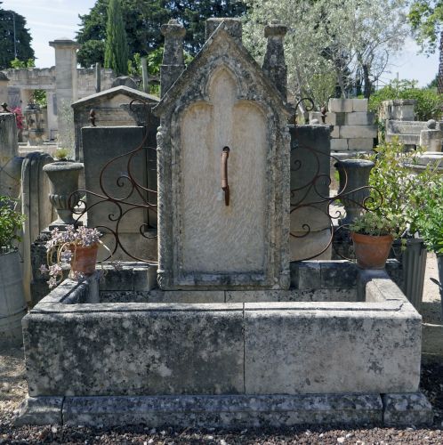 Large fountain: a garden fountain with container and molded base.
