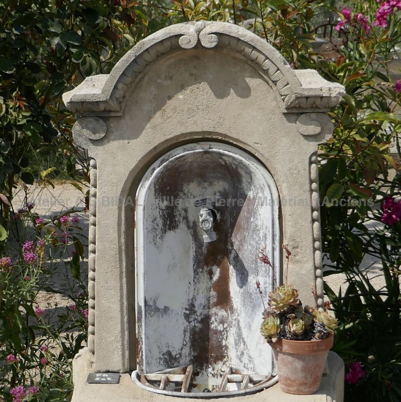 Water fountain signed by Alain Bidal, a fountain made of ancient materials.