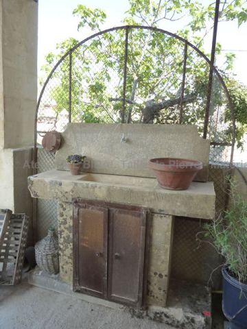 Fireplace in an antic style in Massangis stone , a creation signed by AE Bidal