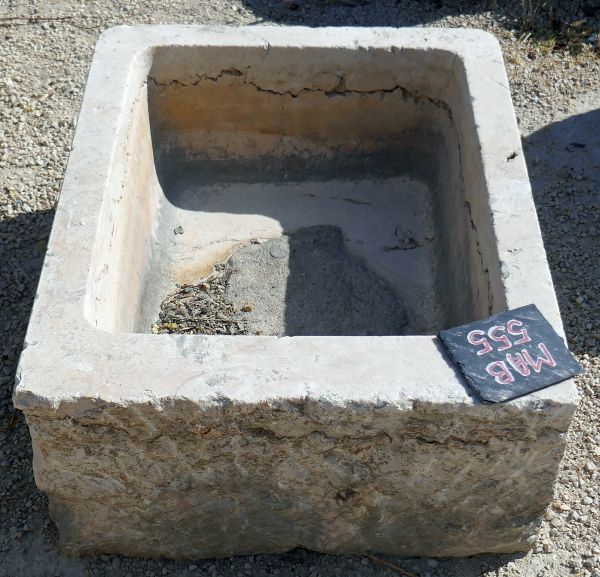 Old hard stone trough weathered and worn by time : small rectangular trough in stone