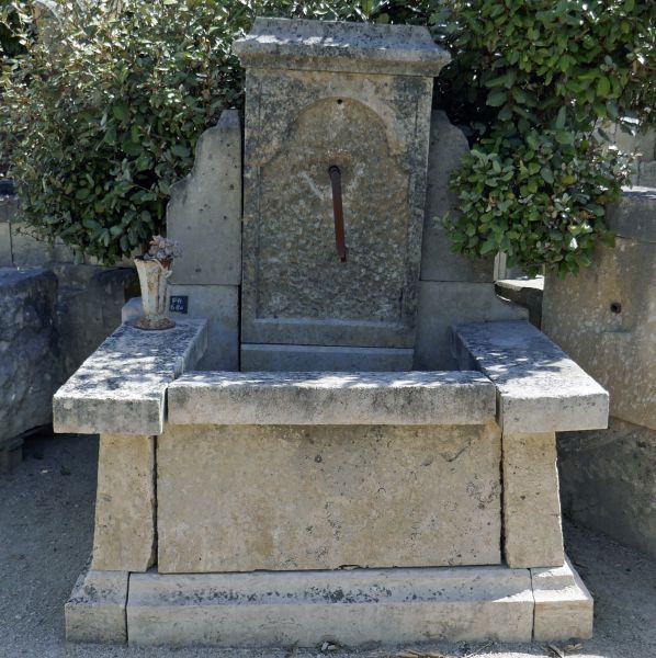 Small fountain - a petite garden fountain in aged and patinated stone