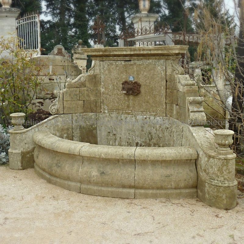 Large wall fountain of Provence | A decorative garden wall fountain with basin and pediment in stone.
