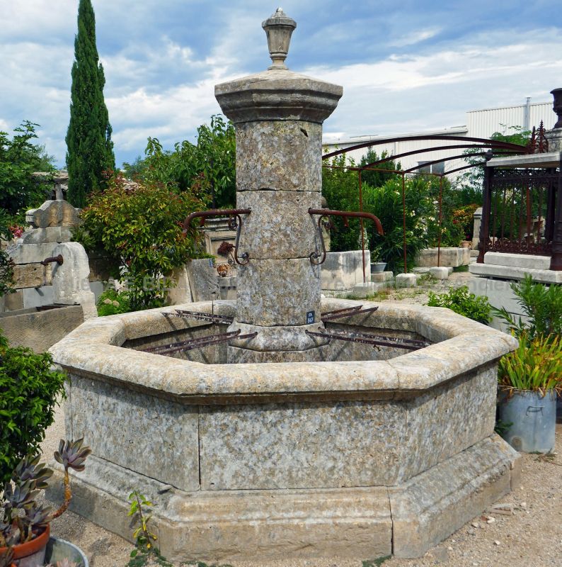 Central fountain made of reclaimed materials - An outdoor fountain with an octagonal basin.