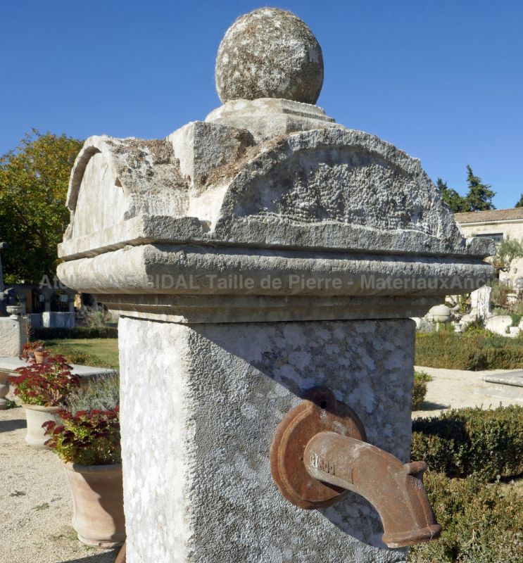 Detail of the sculpted capital with stone ball on our central fountain with 2 basins.