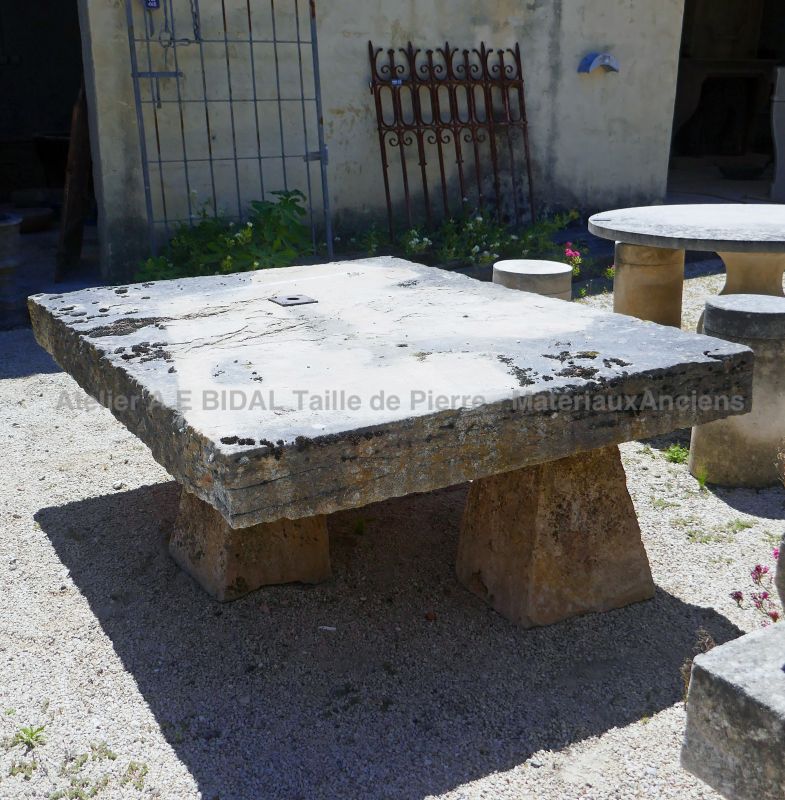Rusticlooking garden table in weathered stones garden furniture