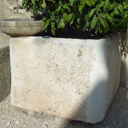 White antique Provence-style stone trough.