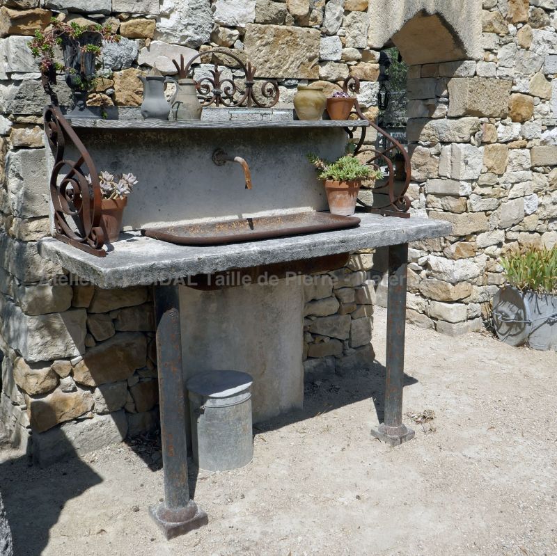 Evier en pierre naturelle avec vasque en fonte ancienne - réalisation Alain BIdal en matériaux anciens.