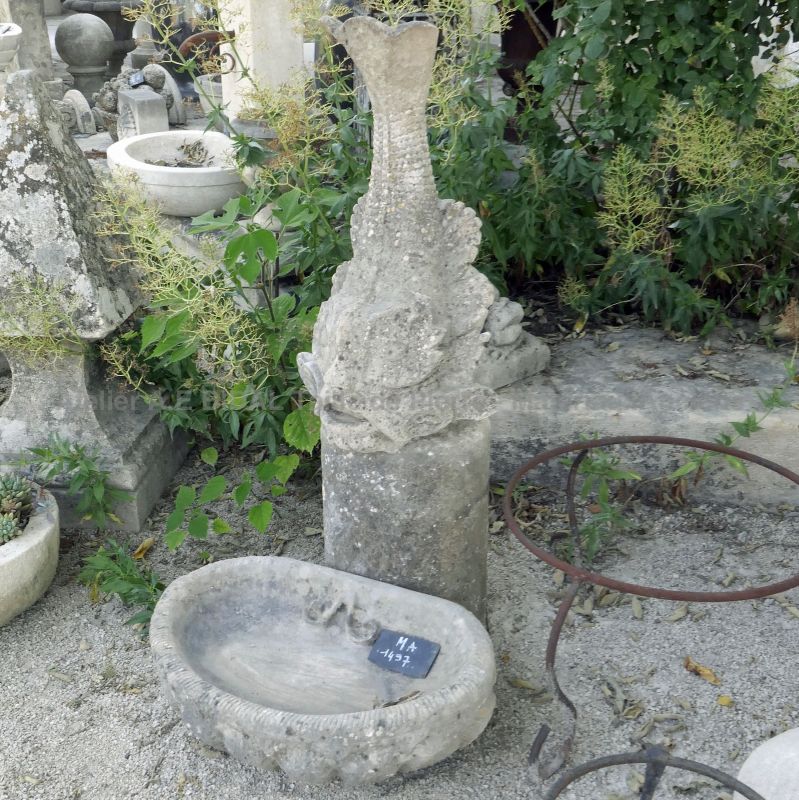 Small and elegant decorative fountain in old stones for garden, balcony or terrace.