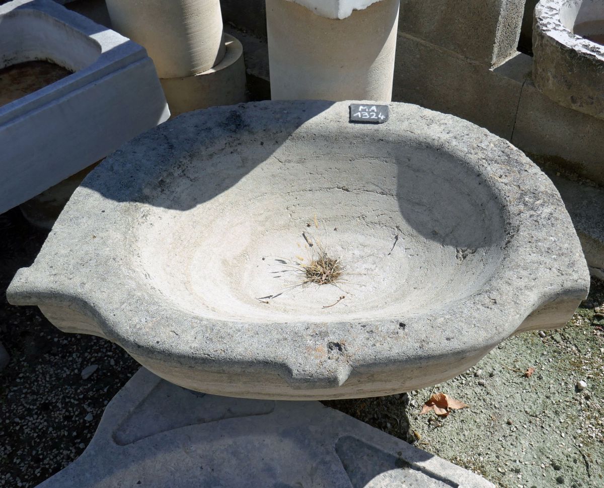 A natural stone trough with a pretty oval shape old sink.