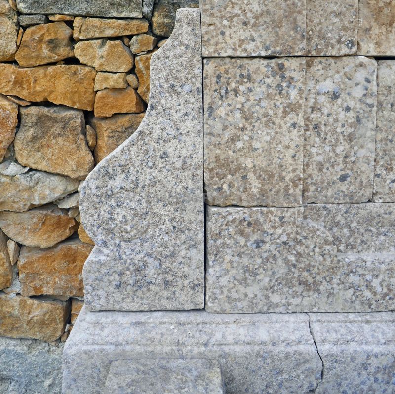 Detailed picture of the corbel and molded copings in weathered stone of our garden wall fountain