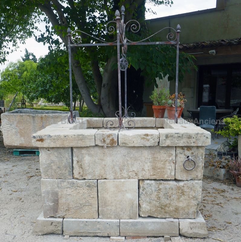 Garden water well in stone and its wrought iron well-top by Atelier Alain BIDAL