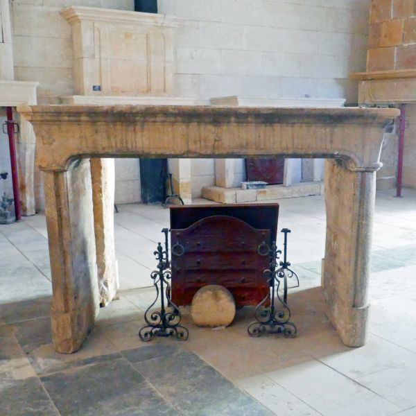 19th century fireplace in stone : a large antique stone mantel by Alain Bidal Antique Materials in Provence