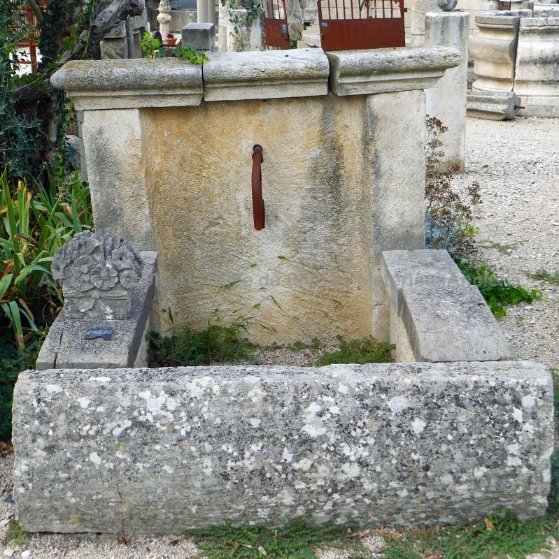 Nice rustic fountain with large copings - a stone fountain composed of a basin and a pediment.