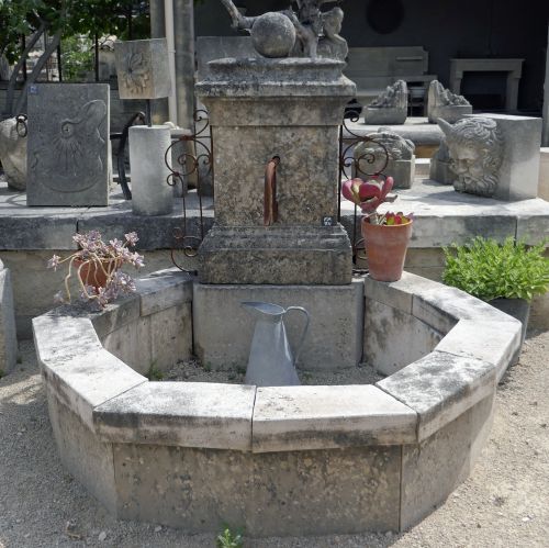 Very charming wall fountain - a stone fountain with an octagonal basin.