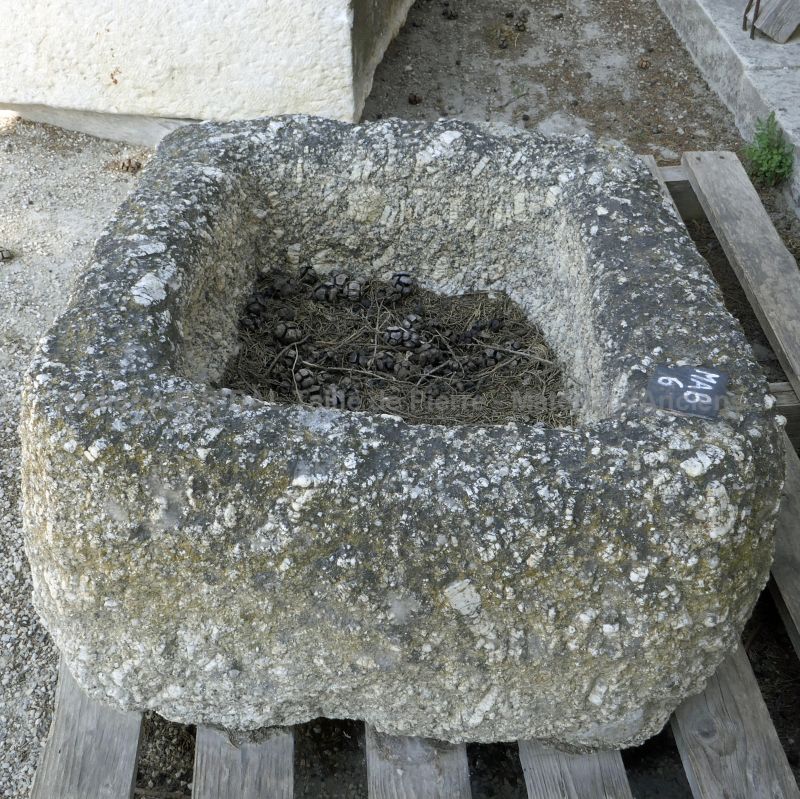 Beautiful flowers pot - antique granite trough for outdoor decoration.