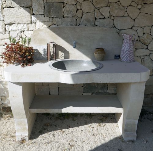 Beautiful practical and solid stone sink for a charming summer kitchen.
