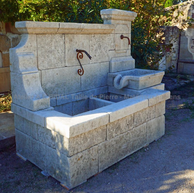 Wall fountain in weathered carved natural limestone : a large fountain from Provence by Atelier Alain BIDAL