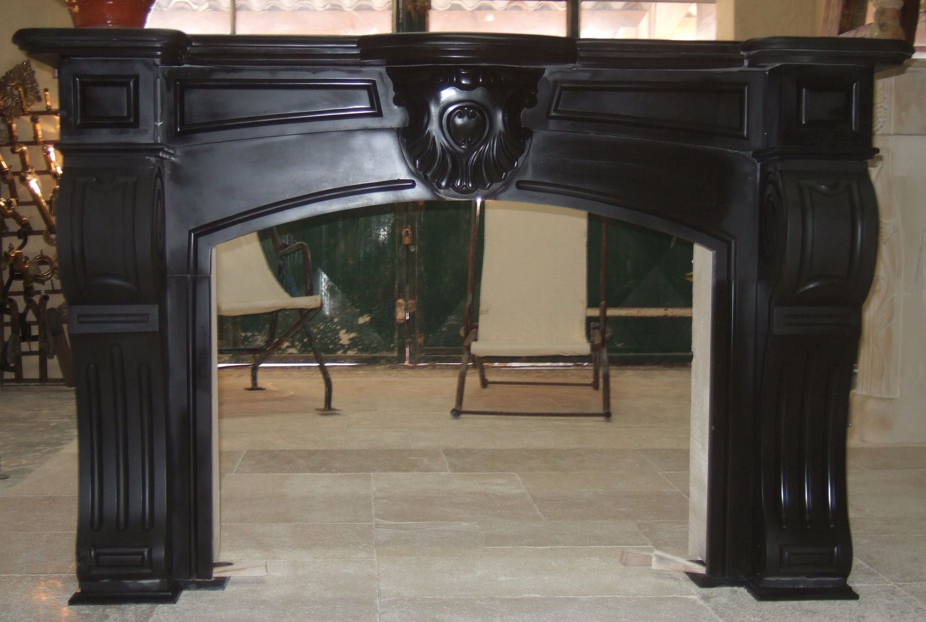 black marble fireplace - a fireplace made of Golzinne black marble in an old fireplace style.