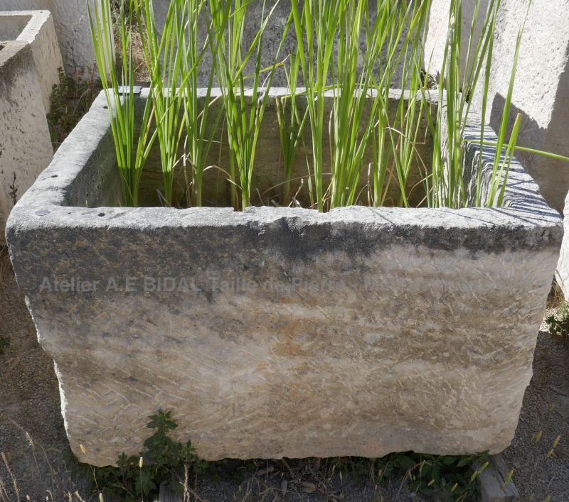 Beautiful trough made of rustic stone - large rectangular basin that can be used as a planter, for example.