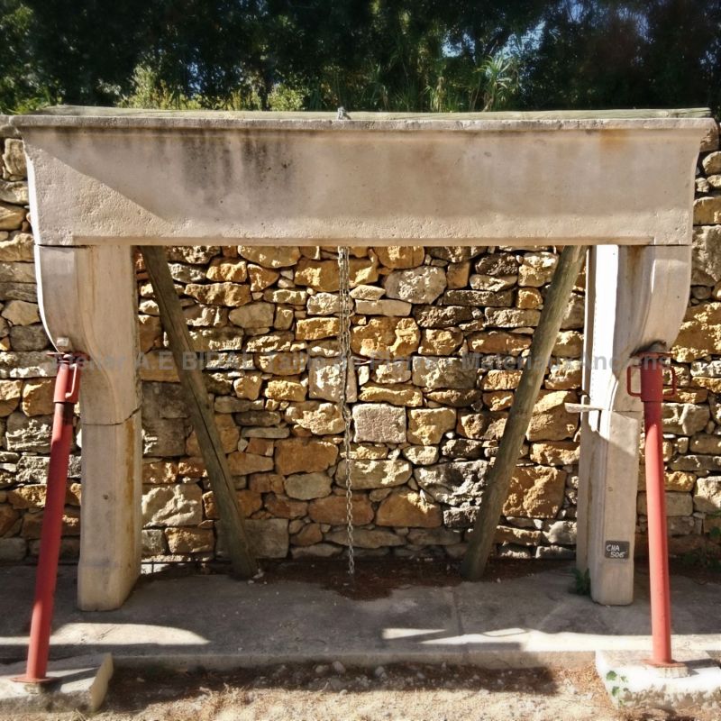 Large old fireplace - 17th century rustic fireplace in light colored stone.
