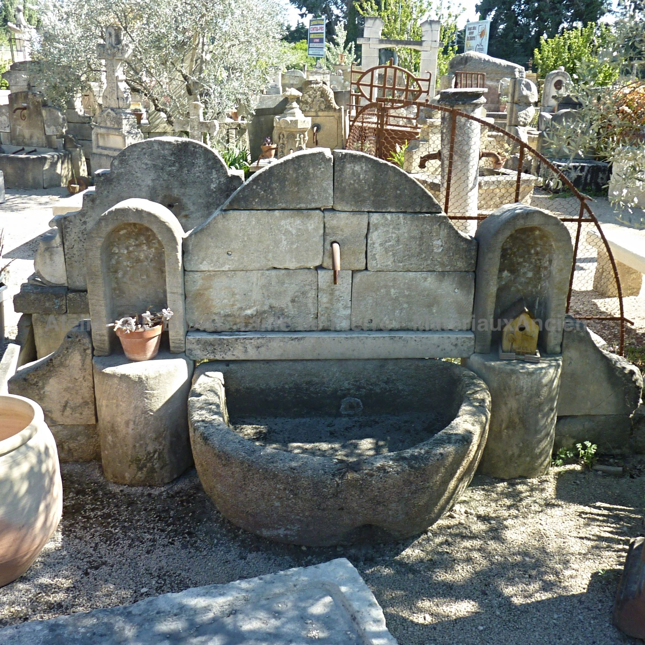 Beautiful garden wall fountain with basin - an elegant and rustic garden fountain.