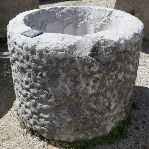 Old stone trough : a circular basin carved by an master craftsman.