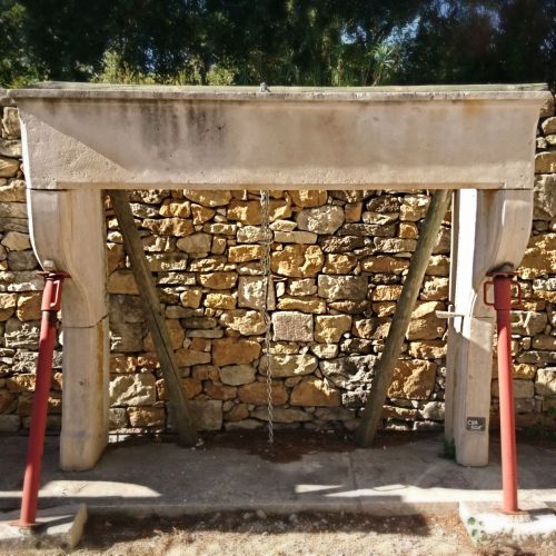 Large old fireplace - 17th century rustic fireplace in light colored stone.