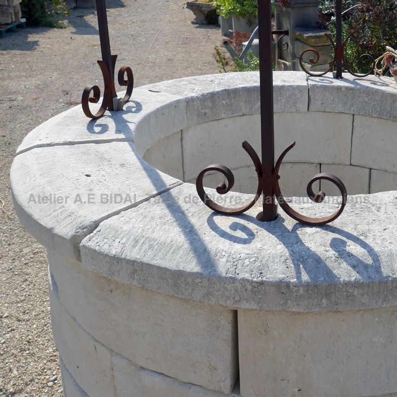 Detail of the large molded copings of the circular garden well in stone by Alain BIDAL Antique Materials in Provence.