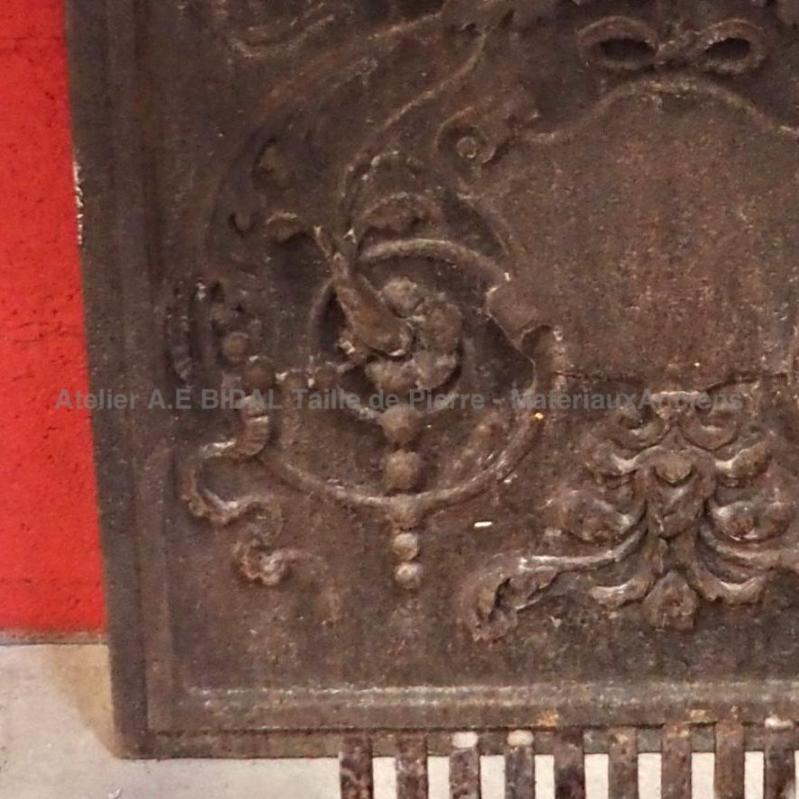 Cast iron fireback representing a lion's head - fireplace accessories made of old materials.