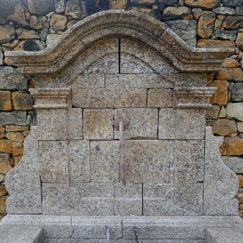 Pediment in patinated stone with an old wrought iron water spout : garden fountain by Atelier Alain BIDAL (Provence)