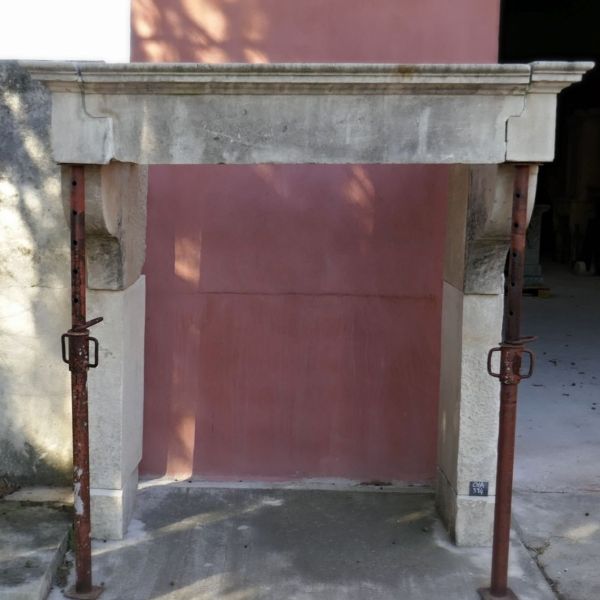 Tall antique Louis XIII stone mantle