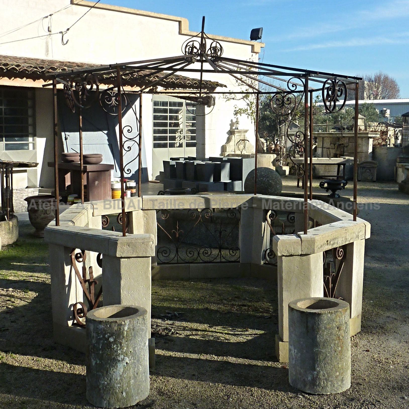 An old-style kiosk with ancient stones and nineteenth-century wrought iron gates.