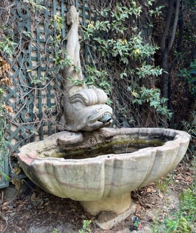 Antique stone fountain with hand-sculpted dolphin by Alain BIDAL Antique Materials in Provence