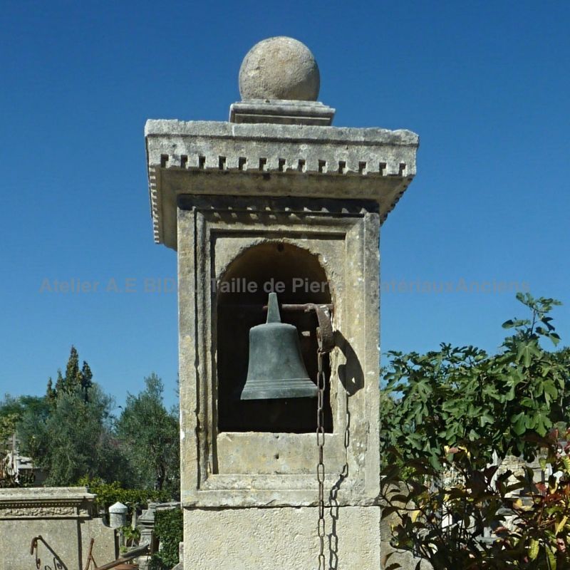 Ancient bell and stone pillar for house gate, small courtyard or small garden.