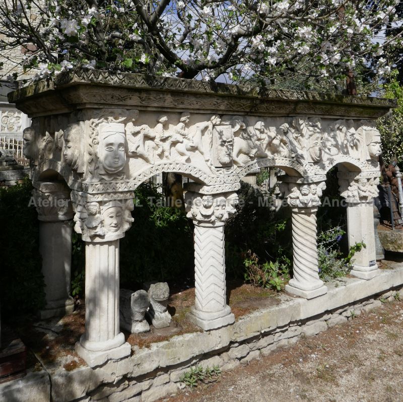 One of a kind old stone fireplace inspired by Roman art.