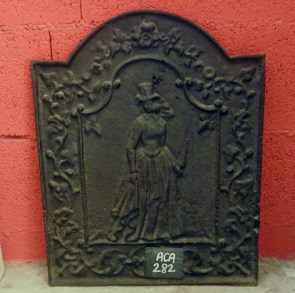 Cast iron fireback representing a woman as well as plants - our old fireplace accessories.