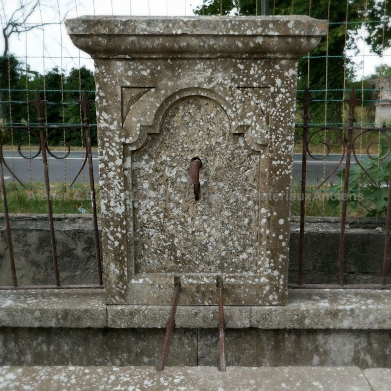 Detail of the pediment on our large antique stone fountain for sale in Provence at Alain BIDAL.
