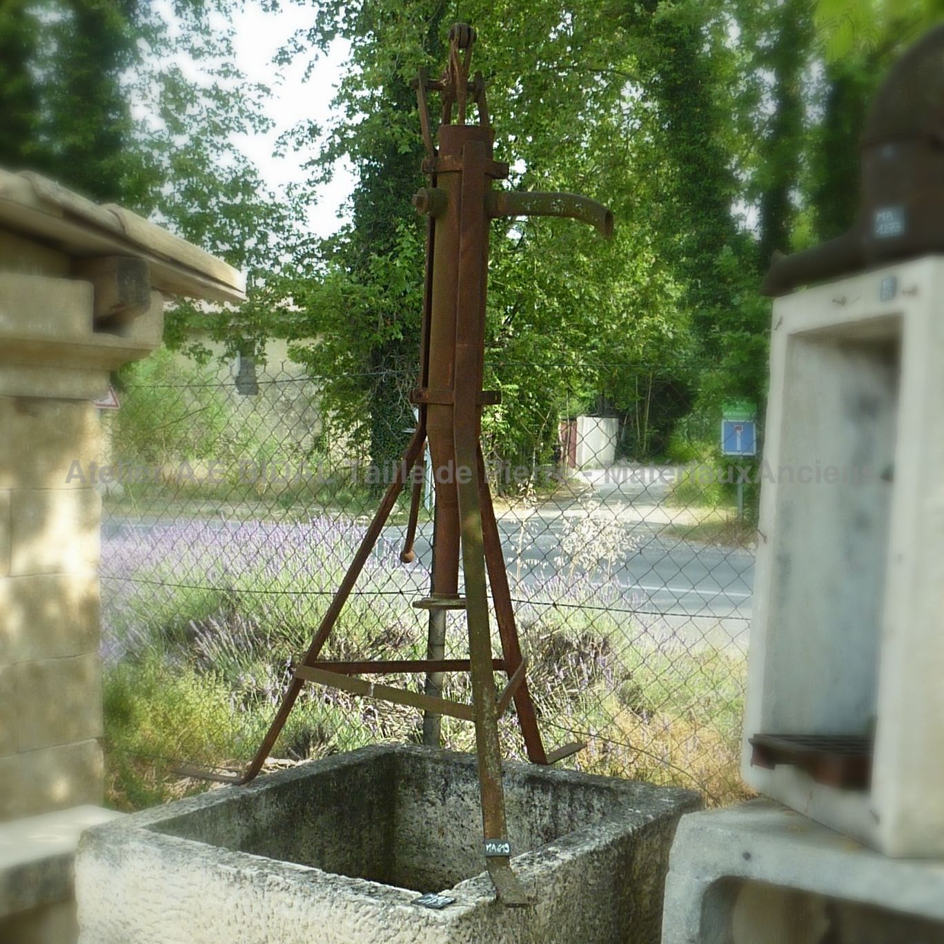 Beautiful hand pump with feet - water pump made of brown iron.