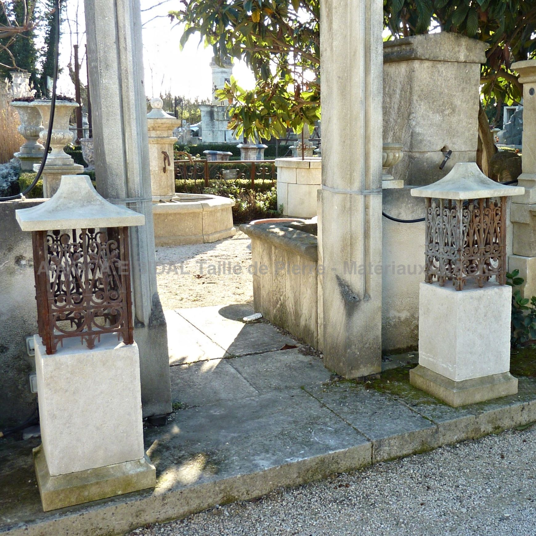 Luminaire on stone base - stone and wrought iron fixture.