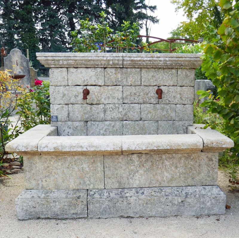 Wall fountain made of reclaimed materials : old stone and iron