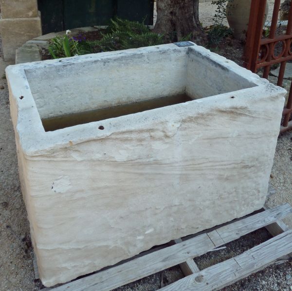 Stone basin with a rustic look that could make a very pretty flower pot or stone planter.