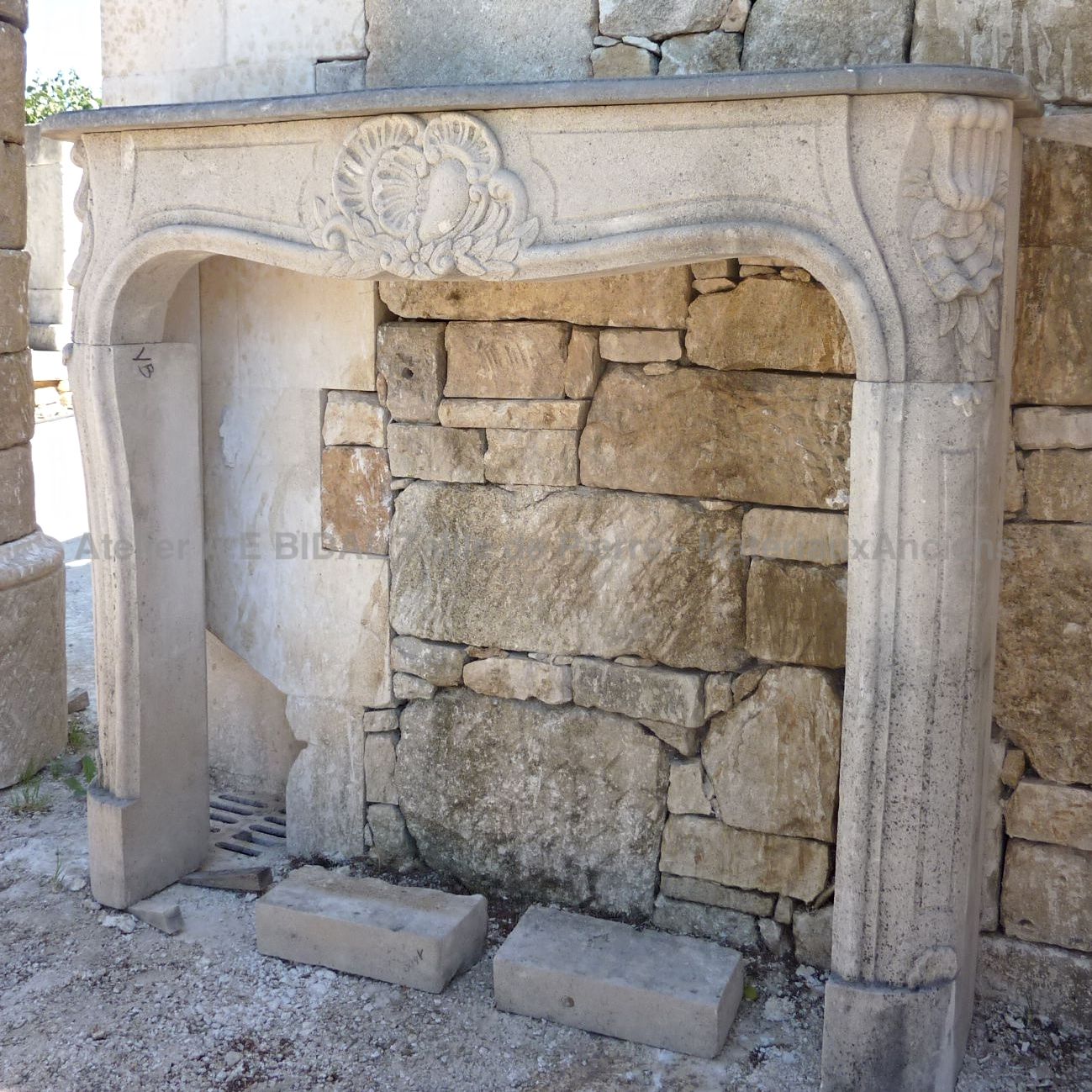 Old fireplace: stone fireplace. 20th century fireplace in Louis 15 style.