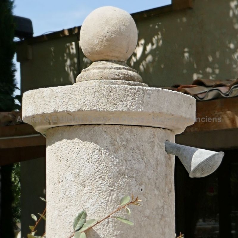 Garden shower | Detail of the stone capital and the old shower head.