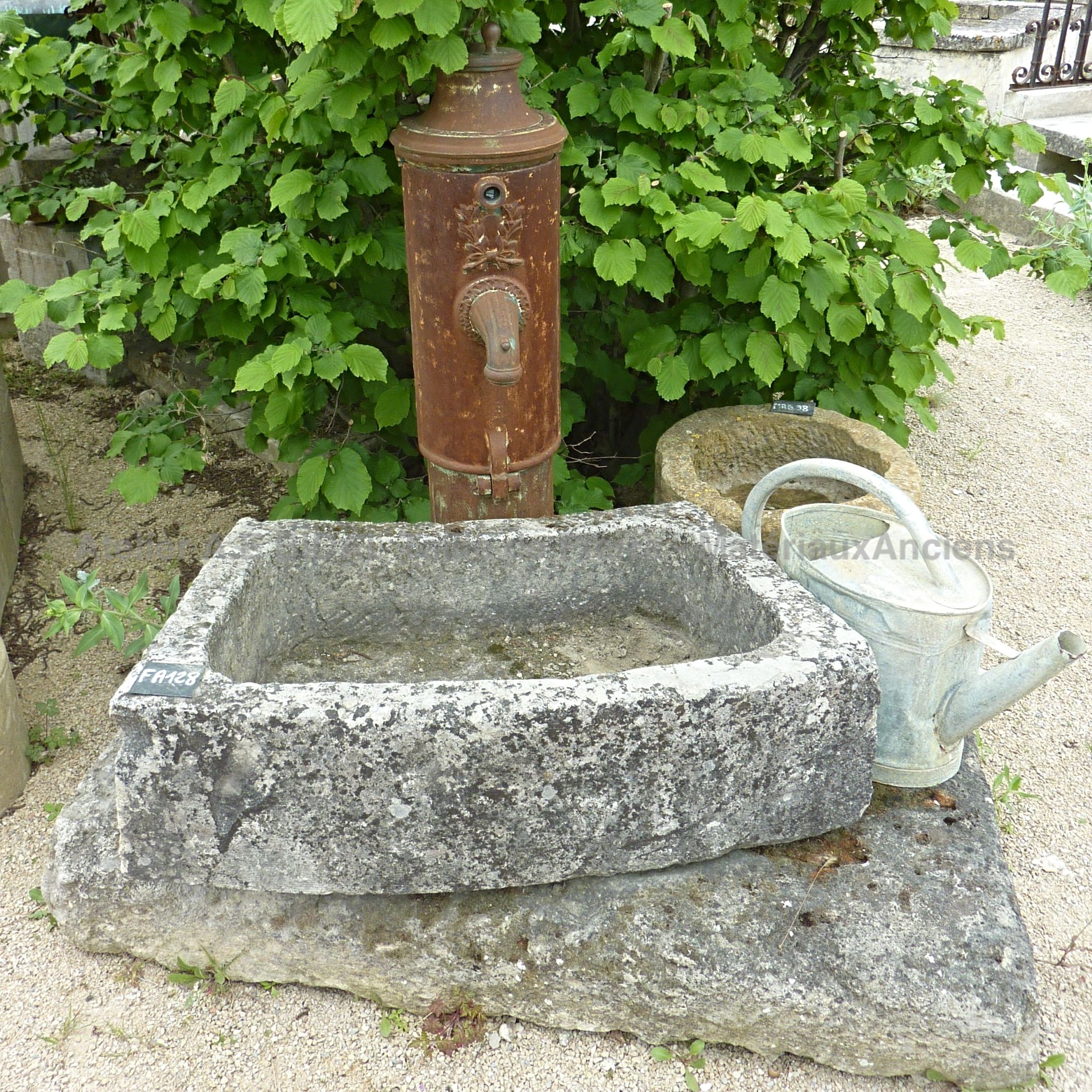 Garden fountain with basin - a garden fountain decorated with a hand pump made of old cast.